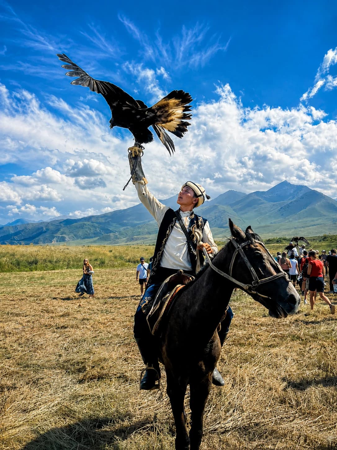 Kyrgyz eagle hunter riding beneath mountain peaks
