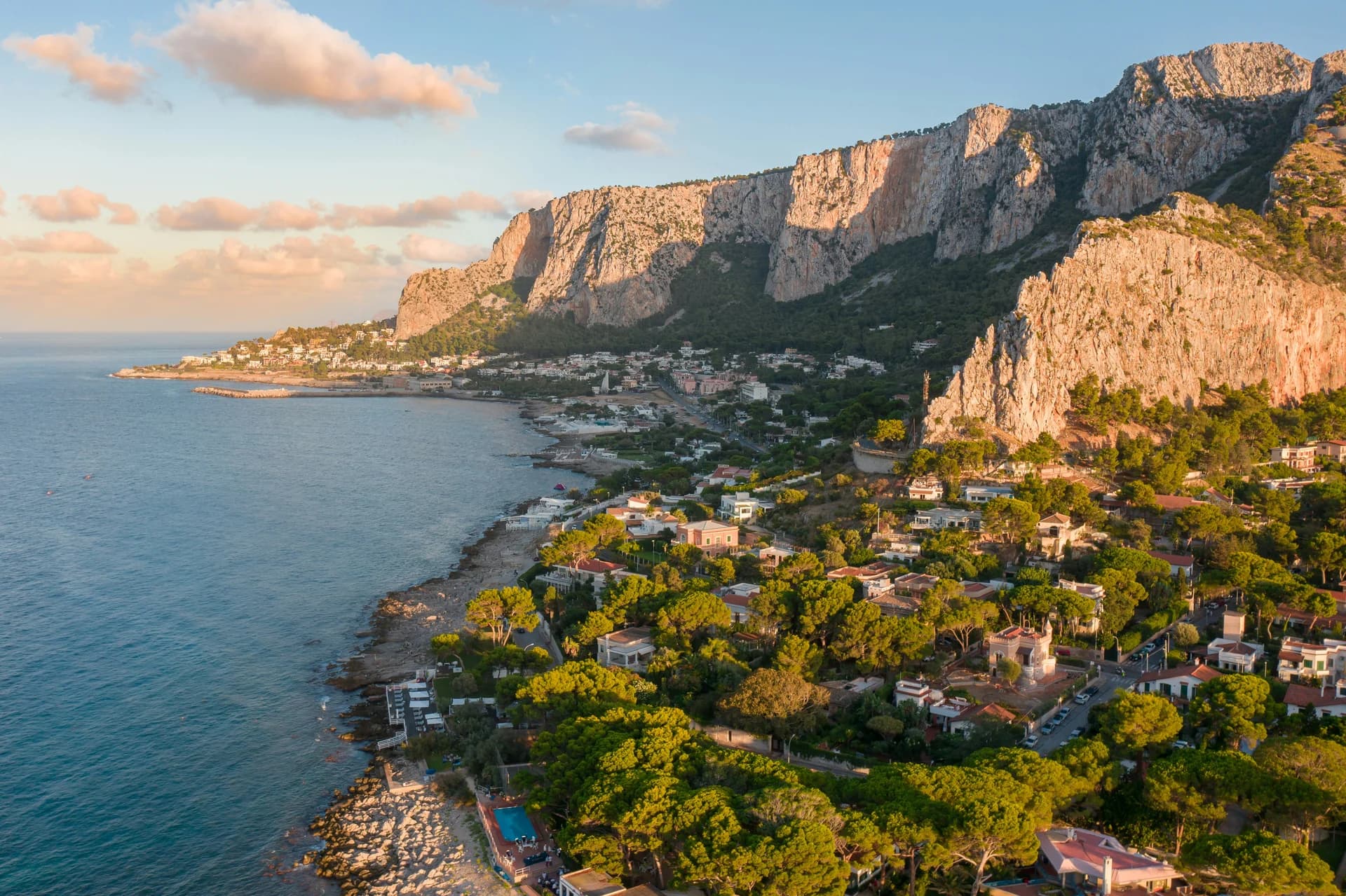 Sicilian coastline and mountain village in golden light
