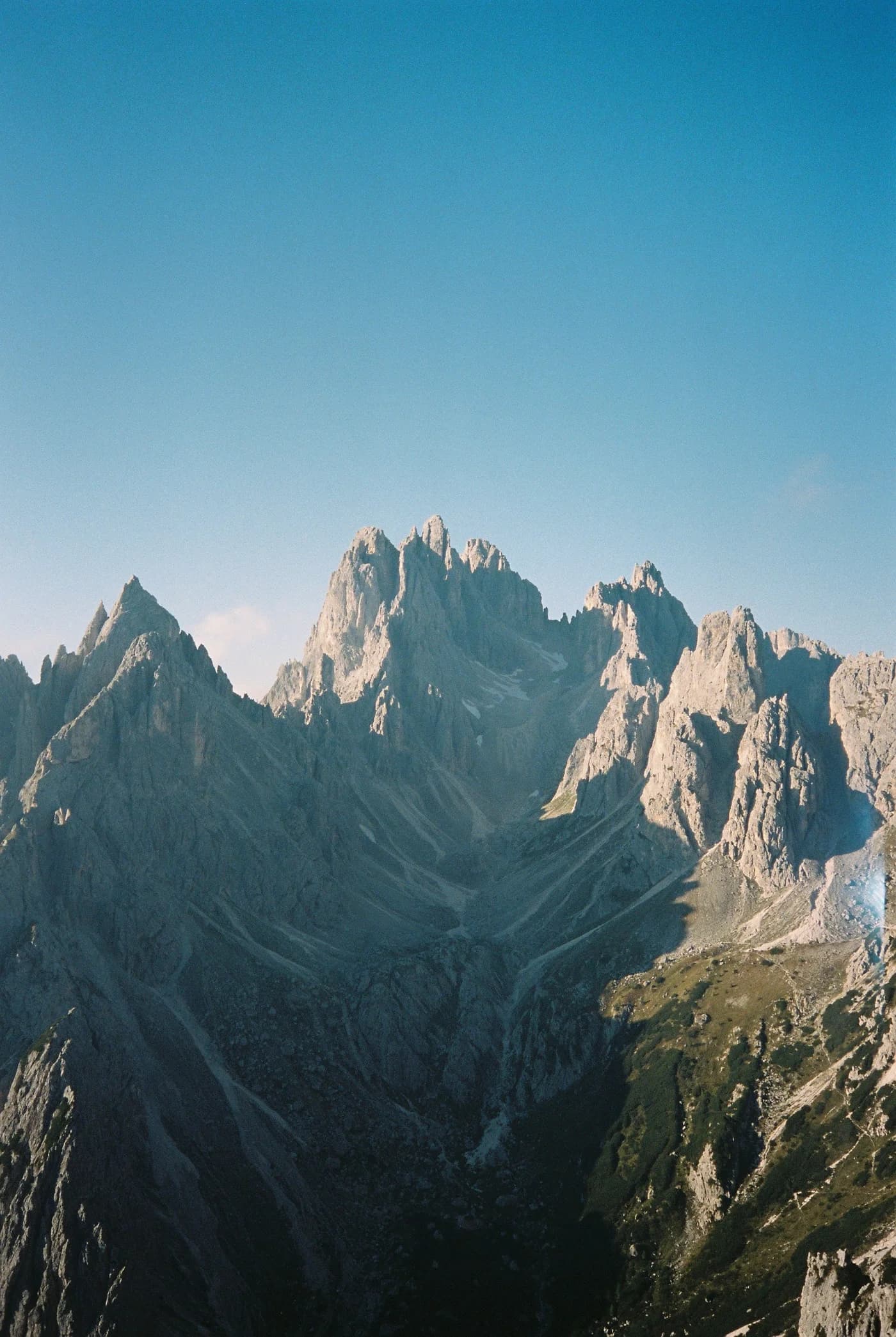 The Dolomites in Trentino rising under a clear blue sky