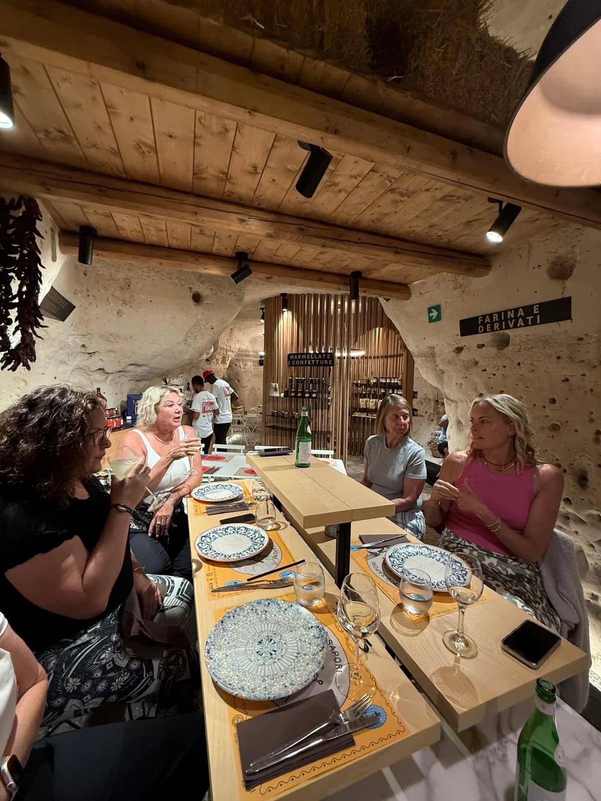 Women sharing a refined dining experience during a curated journey in Italy