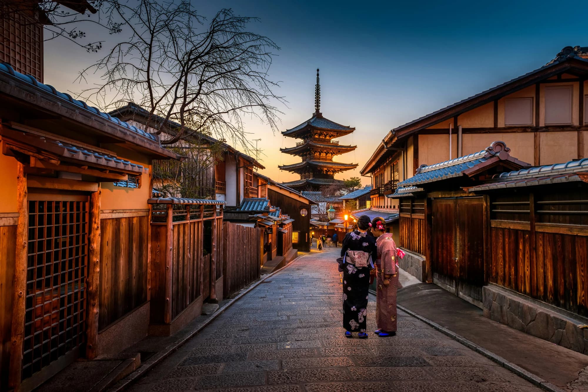 Traditional Kyoto street leading towards a Japanese pagoda